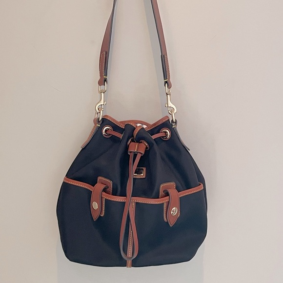 Dooney & Bourke Handbags - Dooney & Bourke drawstring bag. Navy with brown trim. Excellent used condition.